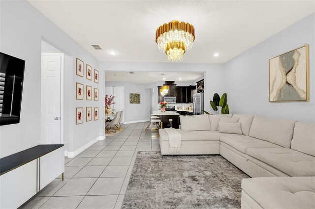 living room with an inviting chandelier and light tile patterned flooring