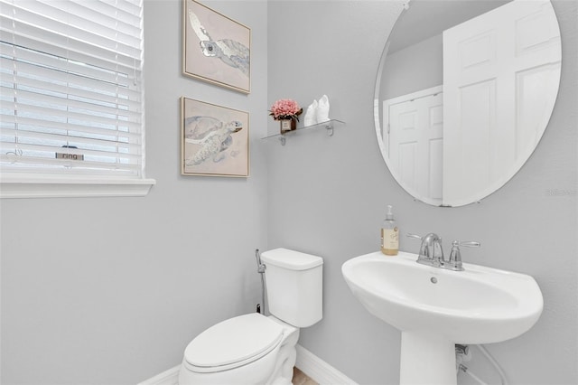 2599 Nouveau Way, Kissimmee, FL 34741 - half bathroom featuring toilet, baseboards, and a sink