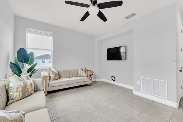 tiled living room with ceiling fan