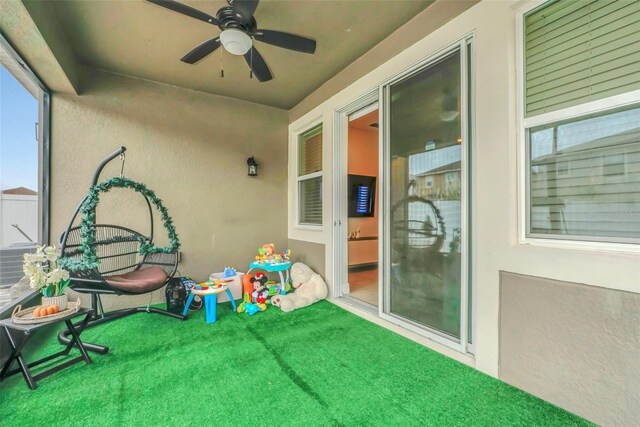 exterior space featuring ceiling fan and carpet floors