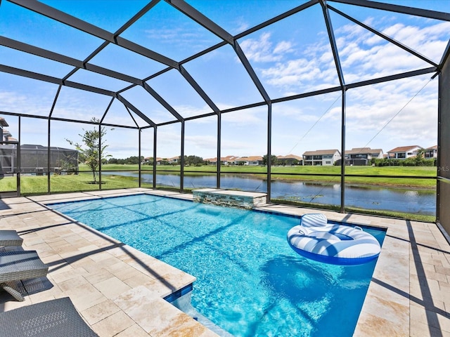 view of pool with a patio, a water view, and glass enclosure