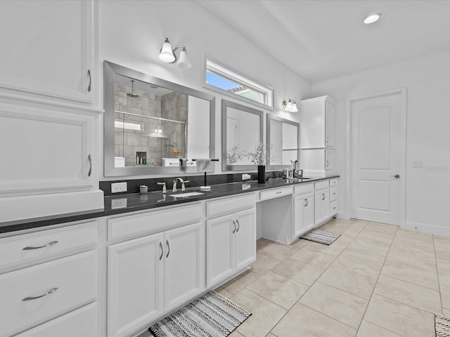 bathroom featuring vanity, tile patterned floors, and tiled shower