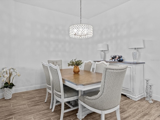 dining room featuring light hardwood / wood-style flooring and a chandelier