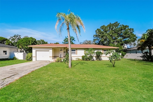 ranch-style home with a front lawn and a garage