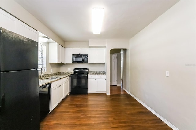 kitchen with black appliances, sink, dark wood-type flooring, and white cabinets