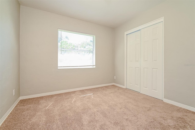 unfurnished bedroom featuring a closet and carpet flooring