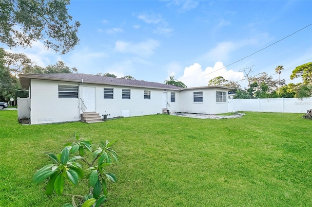 back of property featuring a lawn and a patio area