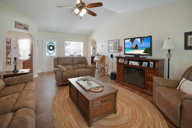 living room featuring ceiling fan, light wood-type flooring, and vaulted ceiling