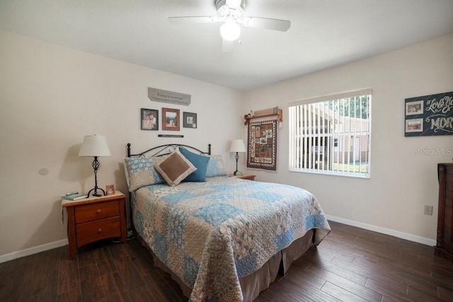 bedroom with dark hardwood / wood-style flooring and ceiling fan