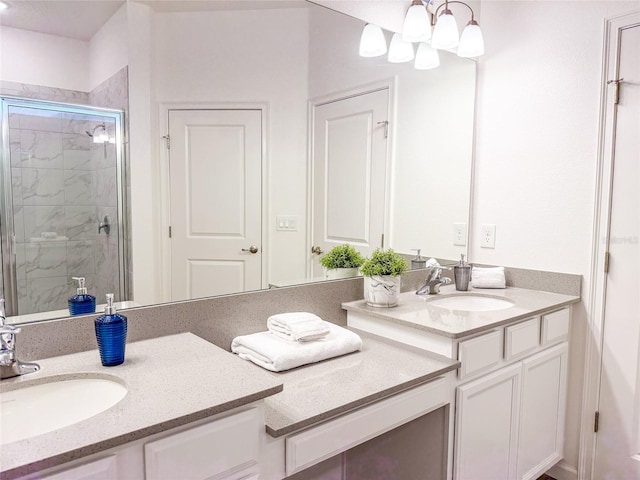 bathroom with vanity, a chandelier, and walk in shower