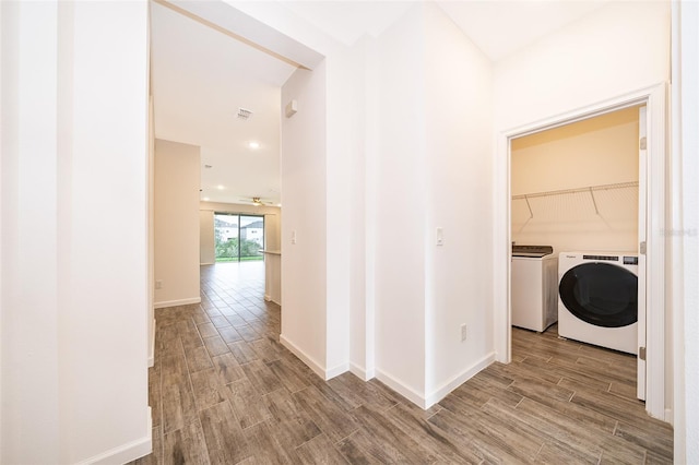 corridor with washing machine and clothes dryer