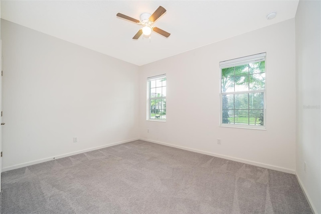 carpeted empty room featuring ceiling fan