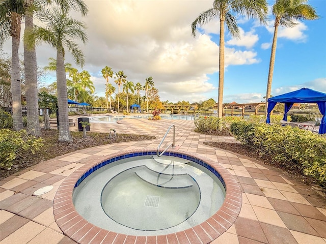 view of swimming pool with a community hot tub