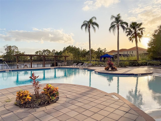 pool at dusk with a patio