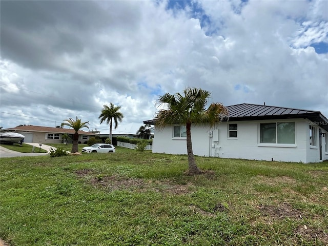 view of side of home with a lawn