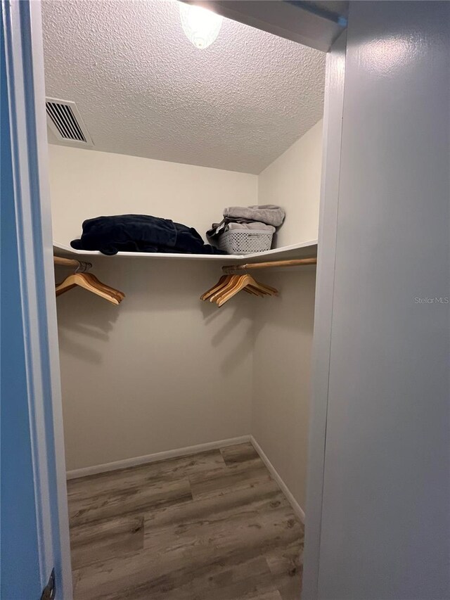 spacious closet featuring hardwood / wood-style floors