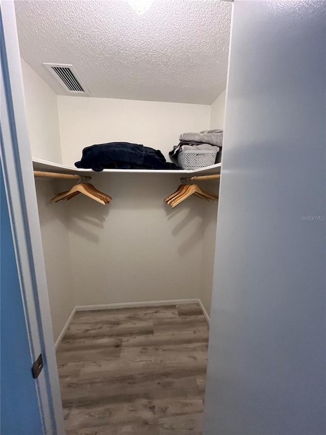 walk in closet featuring hardwood / wood-style flooring