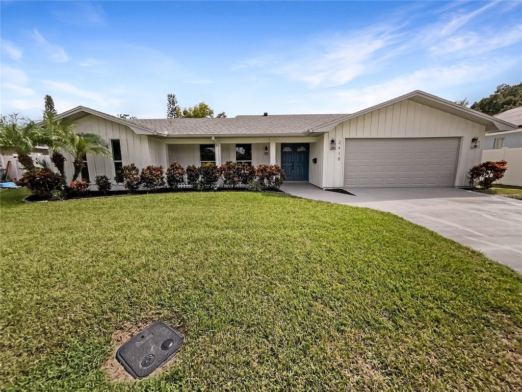 ranch-style house featuring a garage and a front yard