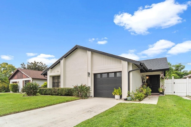 view of front of home with a front yard and a garage