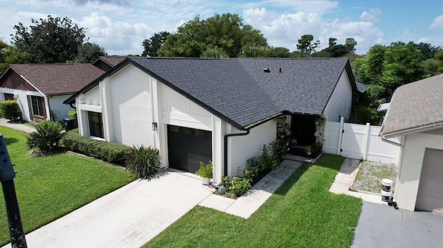 view of front of home with a garage and a front lawn