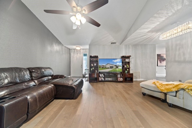 living room with vaulted ceiling, ceiling fan, and light hardwood / wood-style floors