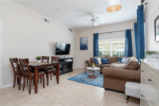 living room with ceiling fan and light tile patterned flooring