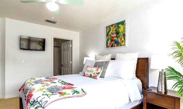 bedroom featuring ceiling fan and carpet