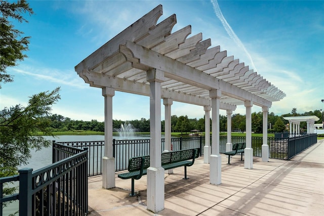 wooden deck with a pergola and a water view