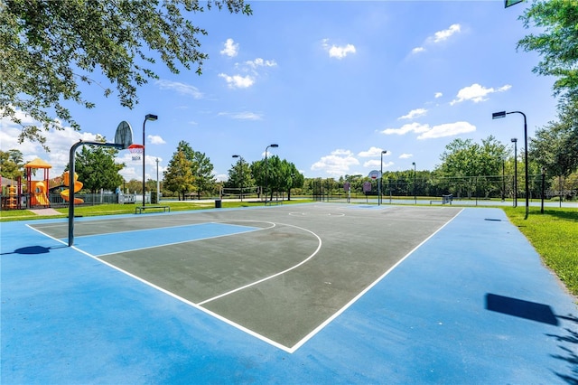 view of sport court with a playground