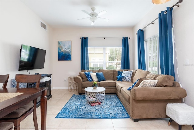 tiled living room featuring ceiling fan