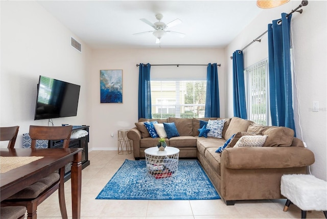 living room with ceiling fan and light tile patterned floors