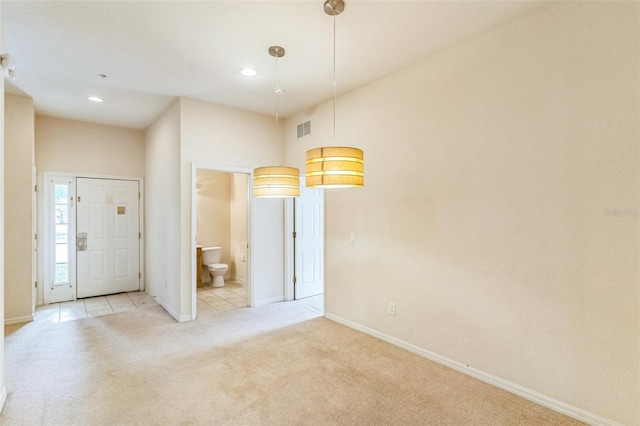 view of carpeted foyer entrance