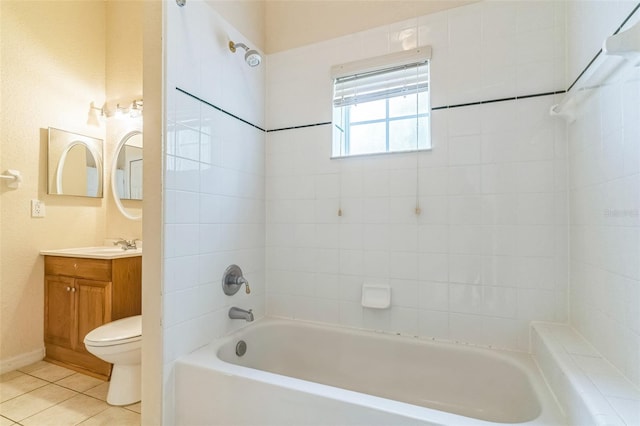 full bathroom with tile patterned flooring, tiled shower / bath, vanity, and toilet