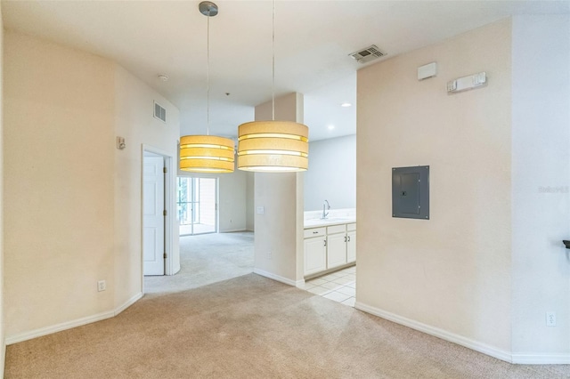 unfurnished dining area featuring light colored carpet and electric panel