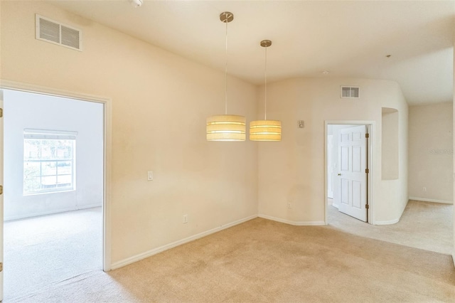 unfurnished room with lofted ceiling and light colored carpet