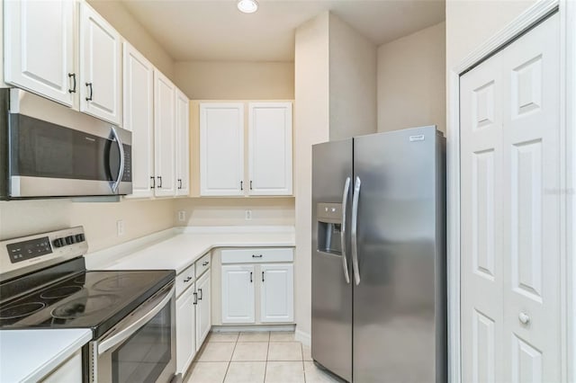 kitchen with white cabinetry, appliances with stainless steel finishes, and light tile patterned floors