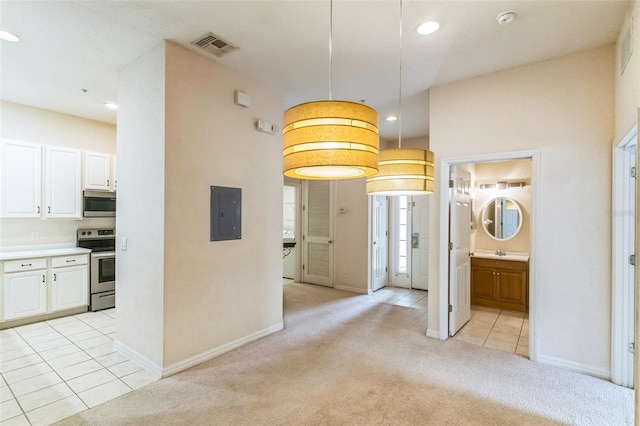 hallway with light colored carpet and electric panel