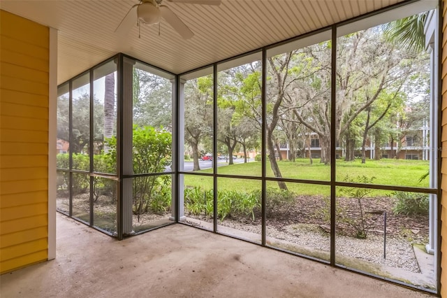 unfurnished sunroom featuring ceiling fan