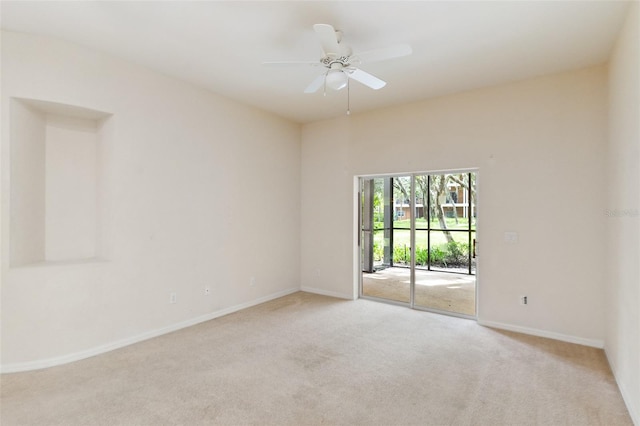 carpeted spare room featuring ceiling fan