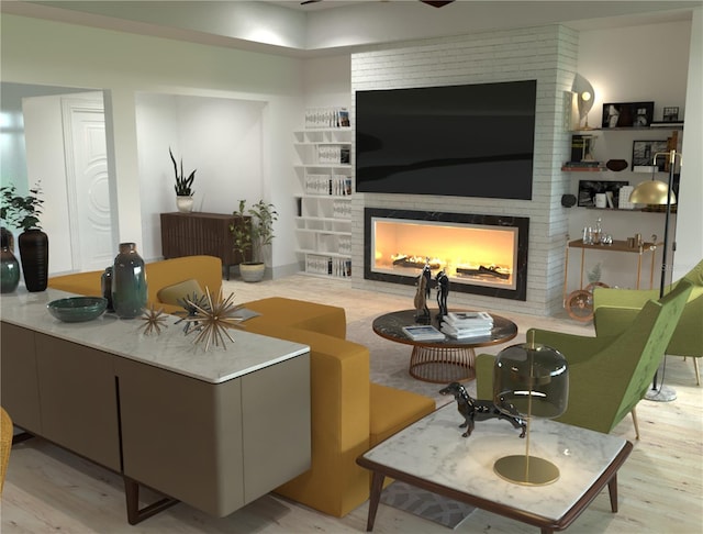 living room with a fireplace and light wood-type flooring