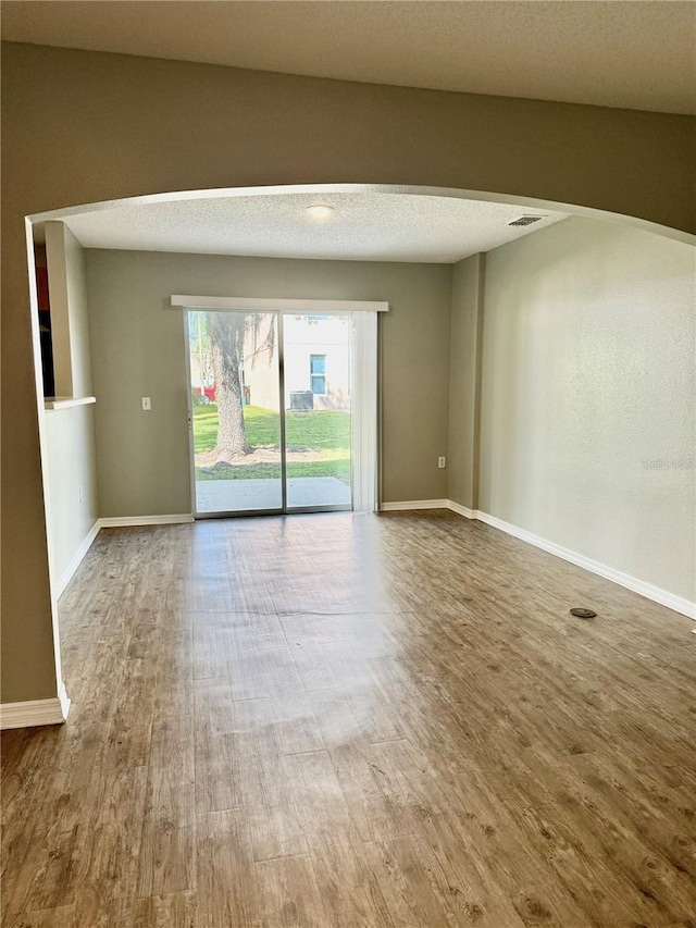 unfurnished room featuring hardwood / wood-style floors