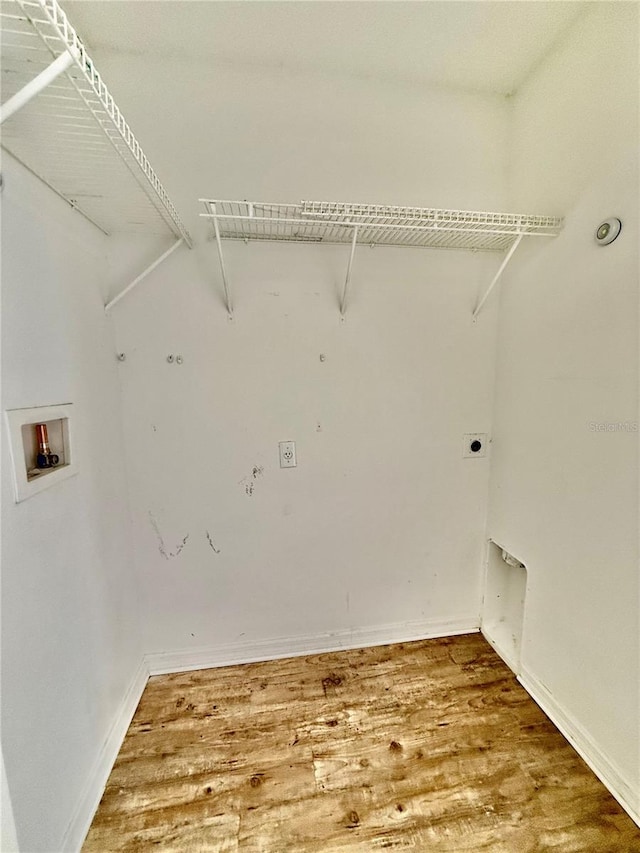 laundry area with hardwood / wood-style flooring, washer hookup, and electric dryer hookup