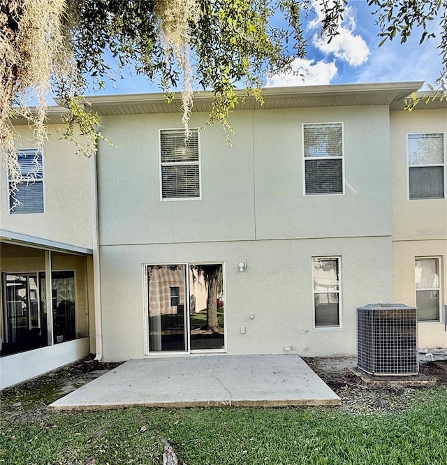 rear view of house featuring a patio and central AC unit