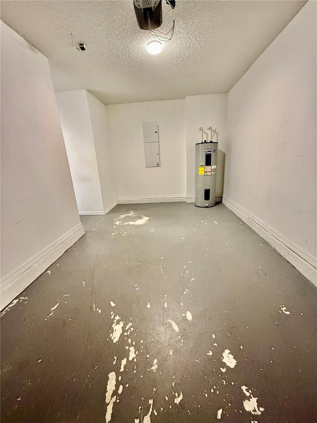 interior space featuring electric water heater and a textured ceiling