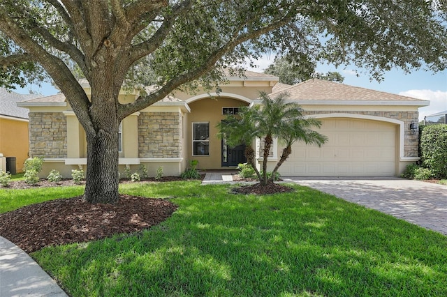 view of front of property featuring a garage and a front lawn