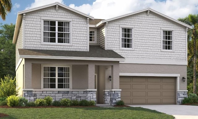 view of front of property featuring a front yard and a garage