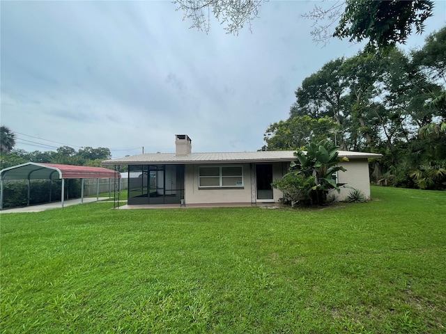 back of property featuring a yard and a carport