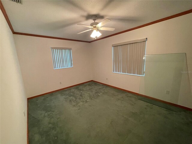 carpeted empty room featuring a textured ceiling, ornamental molding, and ceiling fan