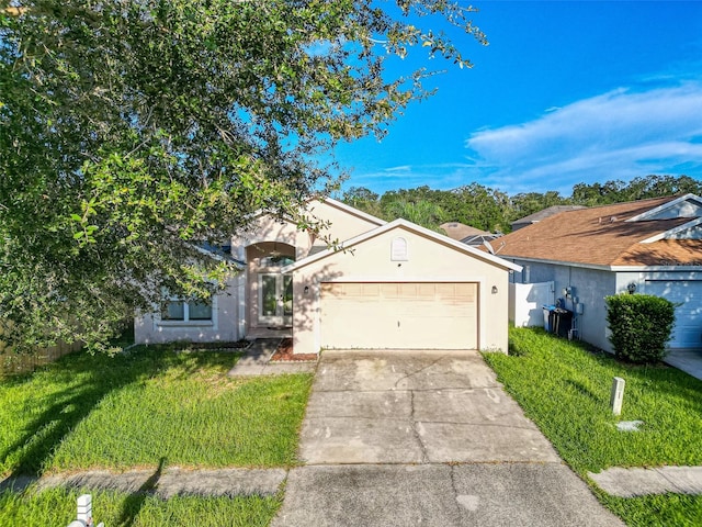 view of front of home featuring a front yard and a garage