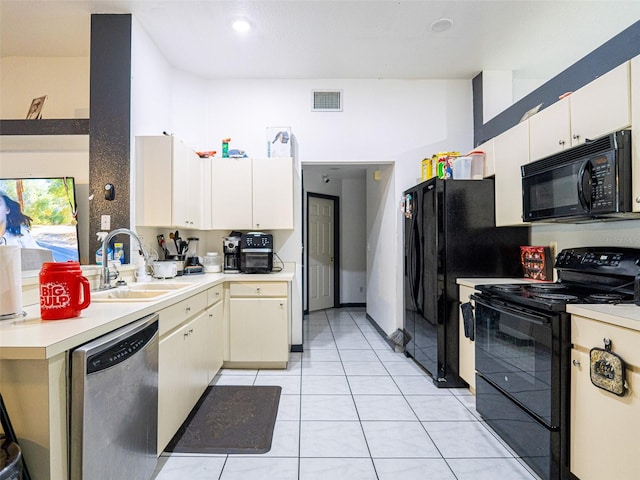 kitchen featuring light tile patterned flooring, black appliances, and sink